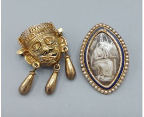 A Regency yellow metal enamel and seed pearl set brooch, 13.5gms together with a yellow metal brooch of maskhead form, 9gms 