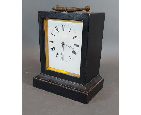 A 19th Century ebonised small table clock, the enamel dial with Roman numerals,15cms tall 