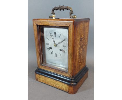 A 19th Century French marquetry inlaid table clock, the silvered dial with Roman numerals and with two train movement, 20cms 