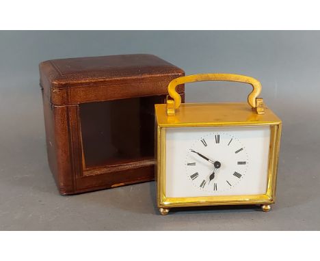 A brass cased carriage clock with leather carrying case 