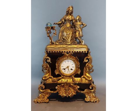 A 19th Century French Ormolu mantle clock, the surmount in the form of a Mother and child, the circular enamel dial with two 