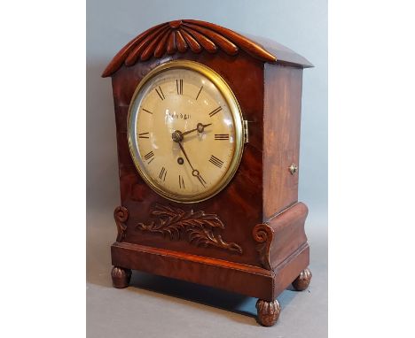 A William IV mahogany cased bracket clock with carved and shaped case,the circular enamel dial inscribed London with Roman nu
