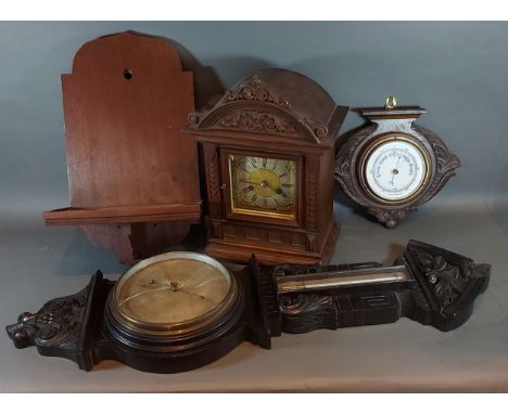 An Edwardian walnut bracket clock with wall bracket together with an oak barometer/thermometer and an oak barometer 