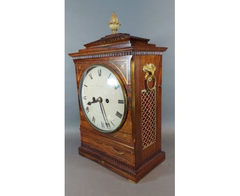 A Regency rosewood and brass inlaid bracket clock, the case with pineapple finial and side ring handles, the enamel dial insc