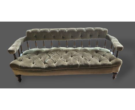 A 19th Century French ebonised and gilded salon sofa with a spindle back above a button upholstered seat raised upon turned l