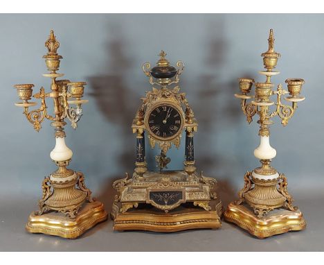 A 19th Century French mantle clock, the circular dial with Roman numerals and two train movement together with a pair of asso