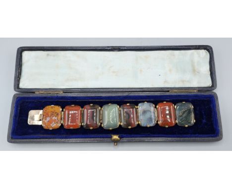 A multi-coloured Agate and yellow metal panel bracelet, 17cms long 