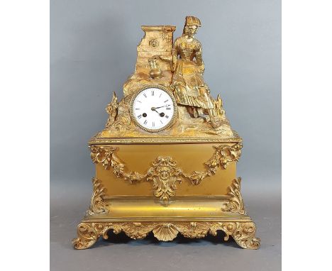 A 19th Century French ormolu mantle clock with figural surmount, the enamel dial with Roman numerals and two train movement, 