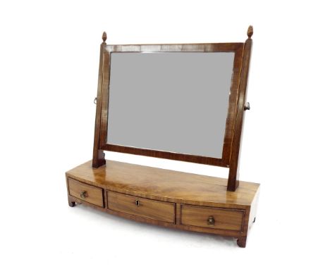 19th century flame mahogany dressing mirror, the swing mirror on a base fitted with three short drawers upon bracket feet, 21