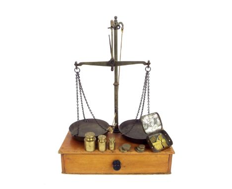 Set of table-top weighing scales with brass column and trays upon a stripped mahogany base fitted with a drawer containing va