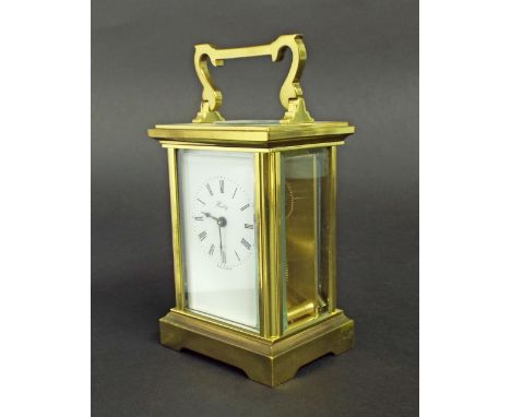 Brass carriage clock in a corniche case with bevelled glass plates, the dial inscribed 'Henley', 5" high