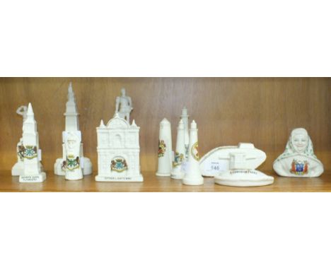 An unmarked crested ware WWI tank, (St Blazey coat of arms), 12cm long, a Devonia Art China 'Citadel Gateway, Plymouth', 11cm