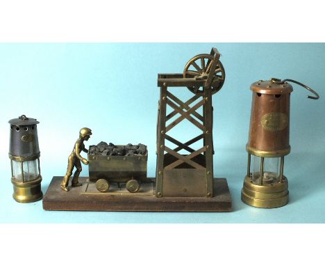A brass model of a colliery and figure pushing a wagon of coal, a Hockley Lamp &amp; Limelight Co. miner's lamp and a miniatu
