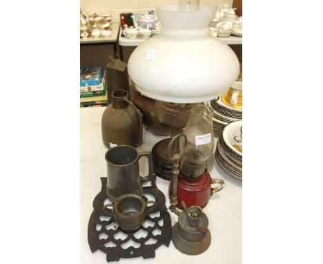 A late-19th century oil lamp, the glass faceted reservoir on metal base, 54cm high overall, a cranberry glass oil lamp fitted