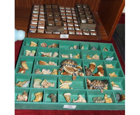 A collection of fifty-five Wade figures and a collection of ceramic thimbles.