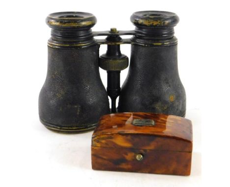 A late 19thC tortoiseshell patch box with domed lid and vacant white metal cartouche, 6cm wide, and a pair of early 20thC ope