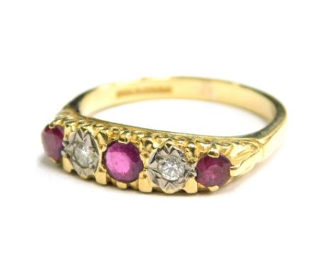 An 18ct gold ruby and diamond set gypsy ring, set with five stones, comprising three rubies and two diamonds, the diamonds in