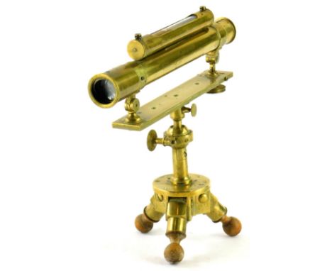 A brass surveyors level, with cylindrical top and spirit level, on a shaped stand terminating in triple legs, marked Nairne N