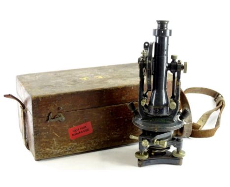 An early 20thC metal cased microscope, with cylindrical centre on an articulated stand, terminating in a tripod base, fitted 