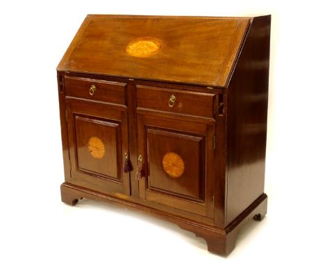 An Edwardian mahogany  bureau, the fall inlaid with a shell enclosing a fitted interior, above two frieze drawers and two pan