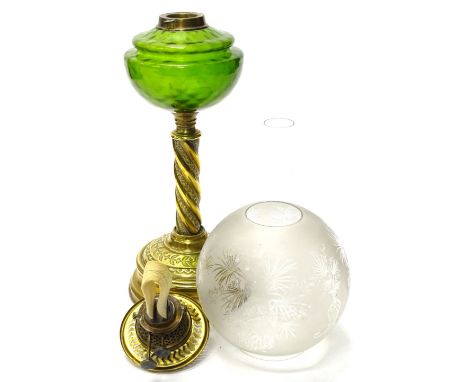 A Victorian brass oil lamp, with a green glass reservoir, and a part frosted shade, the base 38cm high.