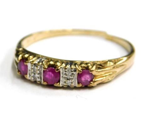 A ruby and diamond set dress ring, set with three rubies and four diamonds, in channel type setting, and yellow metal cut ban