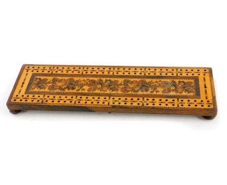 A late 19thC Tunbridge ware cribbage board of rectangular form, on a central floral decoration, an outer pierced border on a 