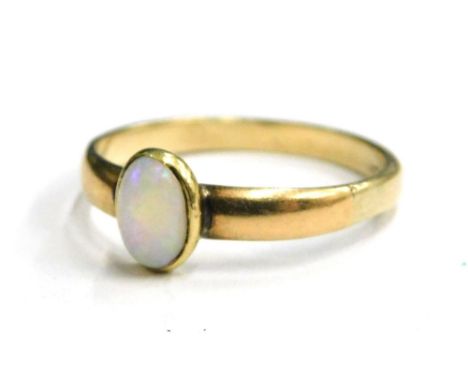 An opal set dress ring, with single oval opal in rub over setting, on a plain band, yellow metal, marked 9ct, ring size P, 2.