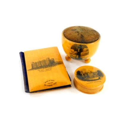 An early 20thC Mauchline ware, sycamore beachy head lighthouse pin cushion of circular form on orb feet, 6cm diameter, a Mauc