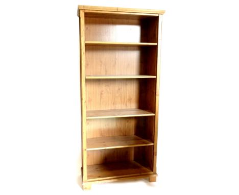 A pine open bookcase, with four adjustable shelves, on bracket feet, 192cm high, 89cm wide.