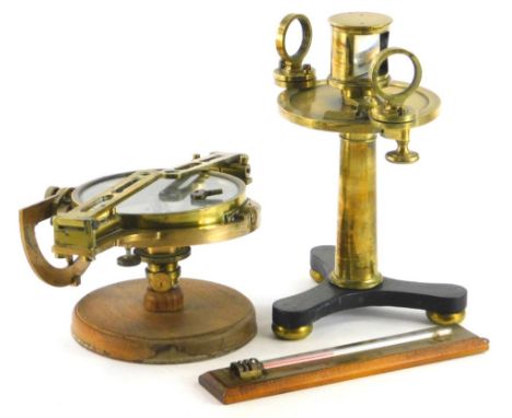A ships compass, of circular form with silvered 11cm diameter dial, in an articulated case with a associated stand.