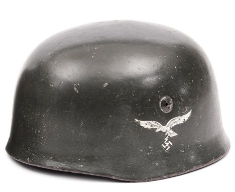 A Third Reich Luftwaffe parachutist’s helmet, the skull with ET maker’s  mark (Eisnhuttenwerke, Thule), the smooth dark grey 