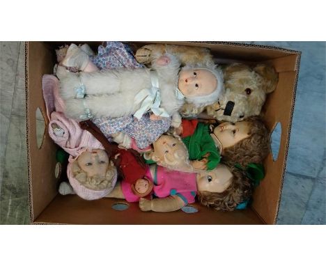 A collection of various felt dolls and a teddy bear