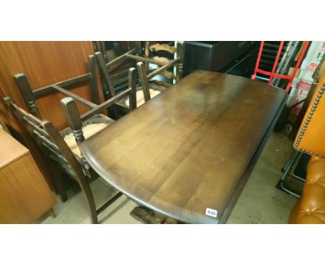 An Ercol table and four chairs
