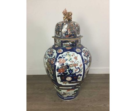 AN EARLY 19TH CENTURY JAPANESE LARGE HEXAGONAL VASE AND COVER,decorated with alternate river landscape and still life panels,