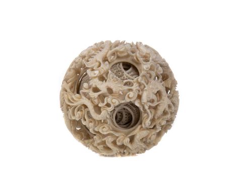 CHINESE IVORY CONCENTRIC PUZZLE BALL,late 19th/early 20th century, eight rings deep, the outer ring carved with dragons and s