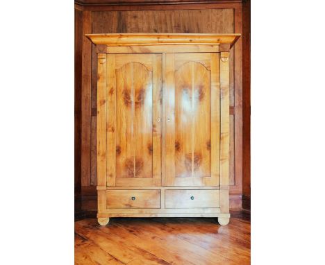 A large Biedermeier maple and fruitwood armoire, the moulded cornice over two panel doors and two drawers below, 160 cm wide,