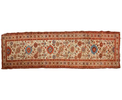 An "Old Country House" ivory ground Malayer runner with large flower heads, within a tiled border, 296 cm x 92 cmA private es