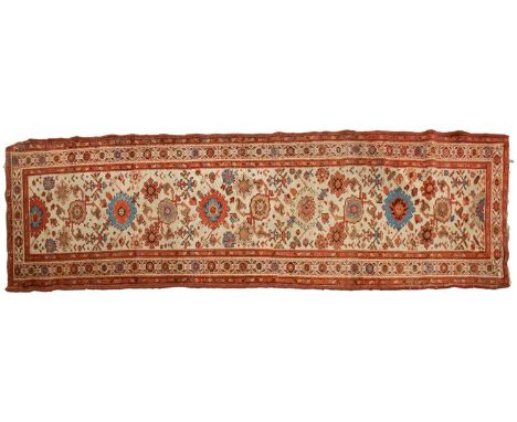 An "Old Country House" ivory ground Malayer runner with large flower heads, within a tiled border, 296 cm x 92 cmA private es