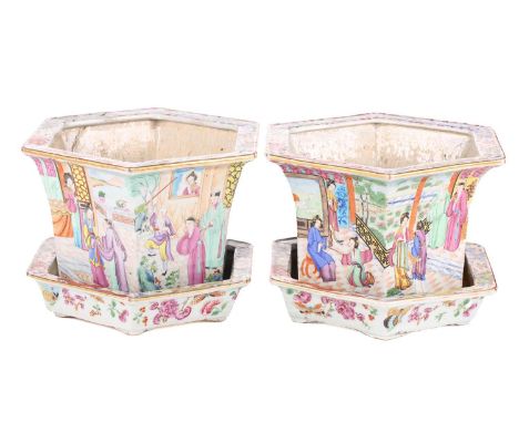 A pair of Chinese famille rose cache pots, of octagonal tapering form, with dragon decorated edges and depicting family scene