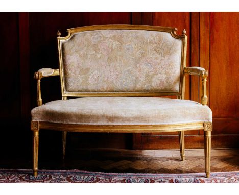 A 19th-century carved wood and gilt gesso two-seat sofa, probably English in the French taste with bowed arched back, the scr