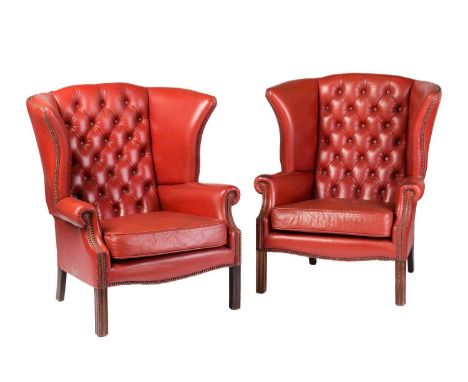 A pair of red leather button back wing armchairs, with moulded square section legs, late 20th century, 98 cm high