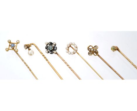 Six Edwardian stick pins – to include an aquamarine, diamond and seed pearl stick pin, pale-yellow old cut diamond stick pin 