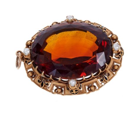 Victorian Cairngorm pendant with a large oval mixed cut Cairngorm in gold mount with black enamel fleur de lys motif and set 