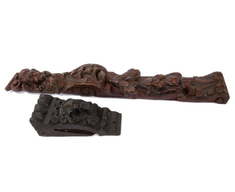 17th century carved oak furniture mount, with mask and fruit ornament, 70cm high, together with 17th century carved oak brack