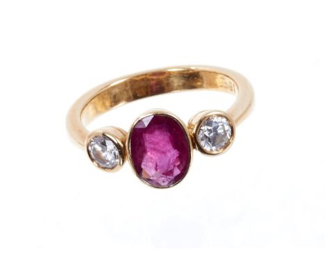 Ruby and diamond three stone ring, the oval mixed cut ruby measuring approximately 8.3mm x 6.3mm x 2.85mm, flanked by two bri