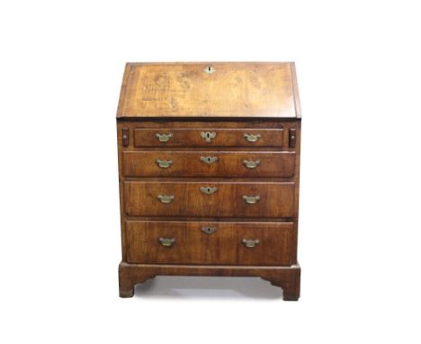 Good early 18th century walnut crossbanded and boxwood strung bureau with hinged fall enclosing fitted stepped interior and f