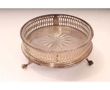 George III silver wine coaster of circular form, with pierced decoration and turned wooden base with unmarked white metal ins