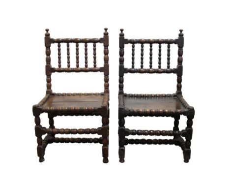 Pair of mid-17th century turned oak chairs with reel and bobbin-turned decoration, panelled seats on conforming supports and 