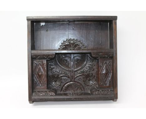 17th century and later carved oak hanging shelf with foliate carved back and lozenge carved supports for the shelves, 48cm wi